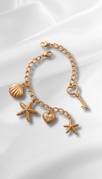 Discover the magic with Pigmenta's anti-tarnish gold charm bracelet featuring a heart key, stars, and seashell. A waterproof, elegant boho piece. Shop now!