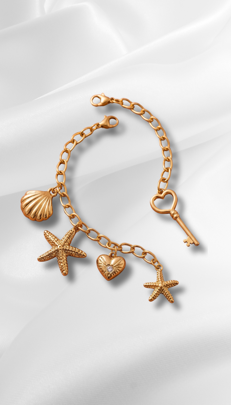 Discover the magic with Pigmenta's anti-tarnish gold charm bracelet featuring a heart key, stars, and seashell. A waterproof, elegant boho piece. Shop now!
